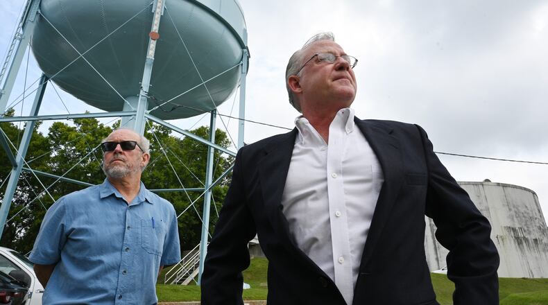 Mike Hackett (right), the director of the city of Rome’s water and sewer division, and Frank Beacham, attorney for the city of Rome, stand outside the City of Rome’s Bruce Hamler Water Treatment Facility in Rome on Tuesday, August 23, 2022. (Hyosub Shin / Hyosub.Shin@ajc.com)