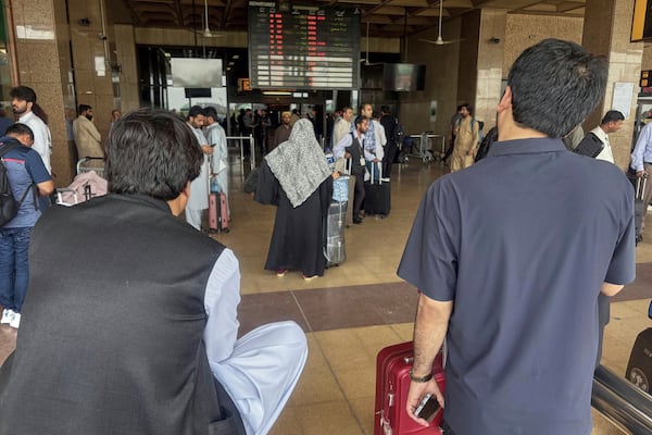 Stranded passengers wait at an arrival area of Jinnah airport after authorities closed the airport due to India's drone attack to Pakistan, in Karachi, Pakistan, Thursday, May 8, 2025. (AP Photo/Mohammad Farooq)