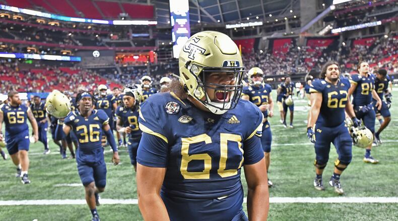 Georgia Tech offensive lineman Paula Vaipulu celebrates after beating North Carolina. (Hyosub Shin / Hyosub.Shin@ajc.com)