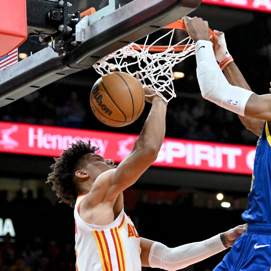 The Atlanta Hawks reportedly have acquired Jonathan Kuminga (right), shown dunking against Jalen Johnson, and Buddy Hield from the Golden State Warriors for center Kristaps Porzingis. (Hyosub Shin/AJC 2024)