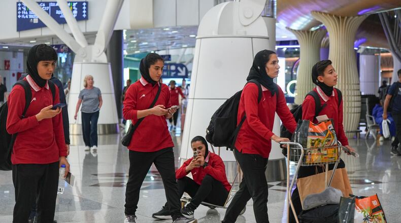 Members of Iran's women's football team arrive at the Kuala Lumpur International Airport in Sepang, Malaysia, Monday, March 16, 2026. (AP Photo/Azneal Ishak)