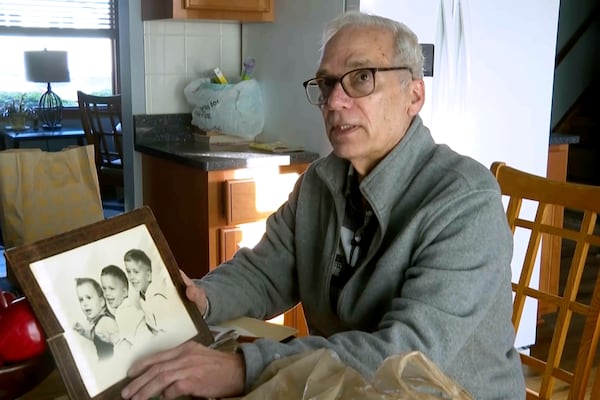 John Prevost, brother of new Pope Leo XIV, holds a portrait of the three Prevost brothers from 1958, Pope Leo, 3, left, John, 4, and Louis, 7, at his home Thursday, May 8, 2025, in New Lenox, Ill. (AP Photo/Obed Lamy)