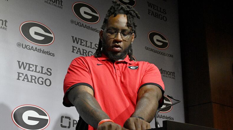 Georgia defensive lineman Zion Logue shows off his College Football Playoff national championship trophy tattoo on his right arm during a press conference at the Butts-Mehre building ahead of spring practice, March 14, 2023, in Athens, GA. (Hyosub Shin / Hyosub.Shin@ajc.com)