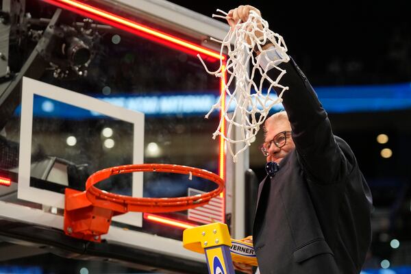 UConn head coach Geno Auriemma holds up the net after defeating South Carolina in the national championship game at the Final Four of the women's NCAA college basketball tournament, Sunday, April 6, 2025, in Tampa, Fla. (AP Photo/Chris O'Meara)