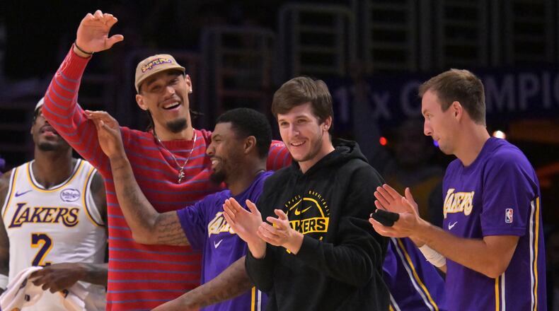 Los Angeles Lakers center Jaxson Hayes, left, Lakers' guard Marcus Smart (36), Lakers' guard Austin Reaves and guard Luke Kennard, right, react after a three-point basket by Lakers' forward Dalton Knecht (4) during the second half of an NBA basketball game against the Utah Jazz, April 12, 2026, in Los Angeles. (AP Photo/Jayne Kamin-Oncea)