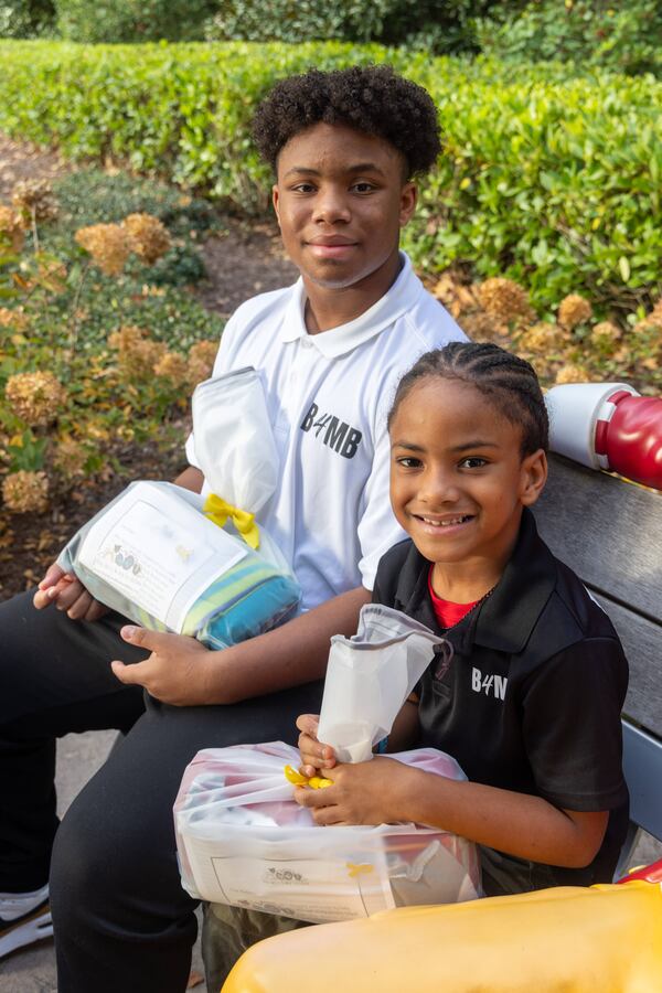 C.J. Matthews (left), age 16 and his brother Kollin, 7, prepare to make a delivery to the Ronald McDonald House as part of their Blankies 4 My Buddies nonprofit. PHIL SKINNER FOR THE ATLANTA JOURNAL-CONSTITUTION
