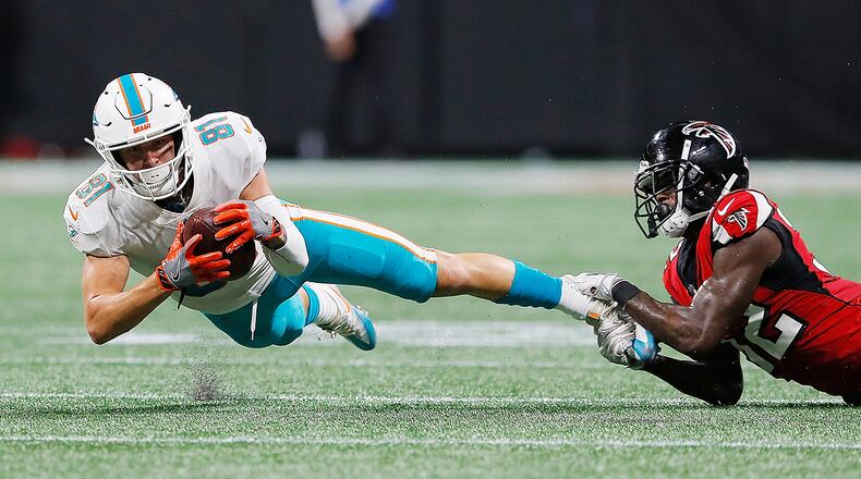 ATLANTA, GA - AUGUST 30:  Drew Morgan #81 of the Miami Dolphins is tackled by Tyson Graham #32 of the Atlanta Falcons at Mercedes-Benz Stadium on August 30, 2018 in Atlanta, Georgia.  (Photo by Kevin C. Cox/Getty Images)