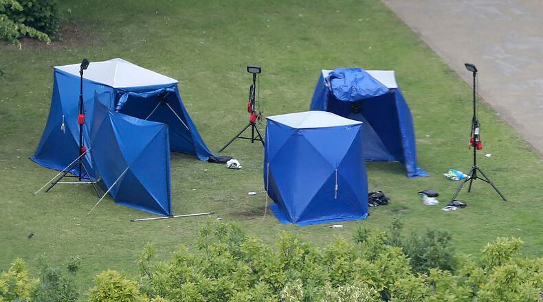 An aerial view shows police tents in Forbury Gardens at the scene of a multiple stabbing attack. A 25-year-old man believed to be the lone attacker is in custody.