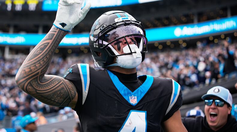 Carolina Panthers wide receiver Tetairoa McMillan celebrates after scoring against the Tampa Bay Buccaneers during the first half of an NFL football game, Sunday, Dec. 21, 2025, in Charlotte, N.C. (AP Photo/Jacob Kupferman)