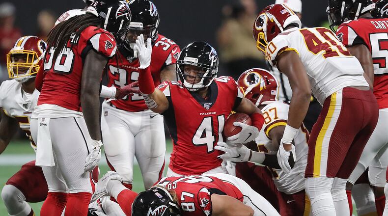 Falcons' Sharrod Neasman picks up a first down on a fake punt against the Washington Redskins. Curtis Compton/ccompton@ajc.com