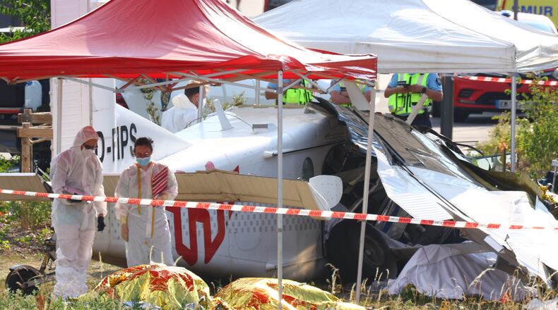 Forensic technicians examine a skydiving plane that crashed in Tomblaine northeastern France, killing all 11 people on board, Sunday, June 28, 2026. (AP Photo/Antonin Utz)
