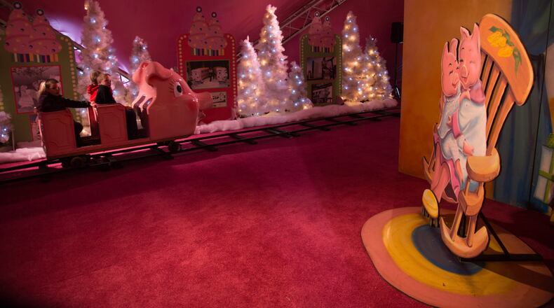 In this file photo, a pink train full of people makes it’s way around the track beneath a 170-foot, 1950s-themed Macy’s Pink Pig tent. STEVE SCHAEFER / SPECIAL TO THE AJC