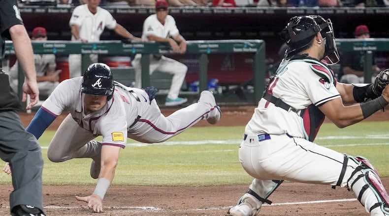 Austin Riley scores the winning run in the 11th inning of Monday's win over the Diamondbacks.
