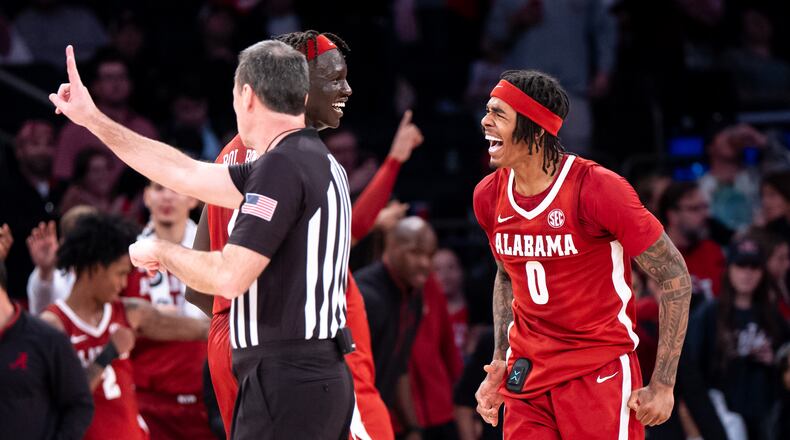 Alabama forward Taylor Bol Bowen (7) and guard Labaron Philon (0) celebrate a basket near the end of an NCAA college basketball game against St. John's, Saturday, Nov. 8, 2025, in New York. (AP Photo/Angelina Katsanis)