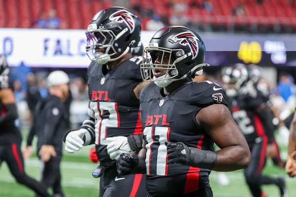 Atlanta Falcons linebacker Jalon Walker (11), right, warms up before an NFL preseason game against the Detroit Lions at Mercedes-Benz Stadium in Atlanta on Friday, August 8, 2025. (Arvin Temkar / AJC)