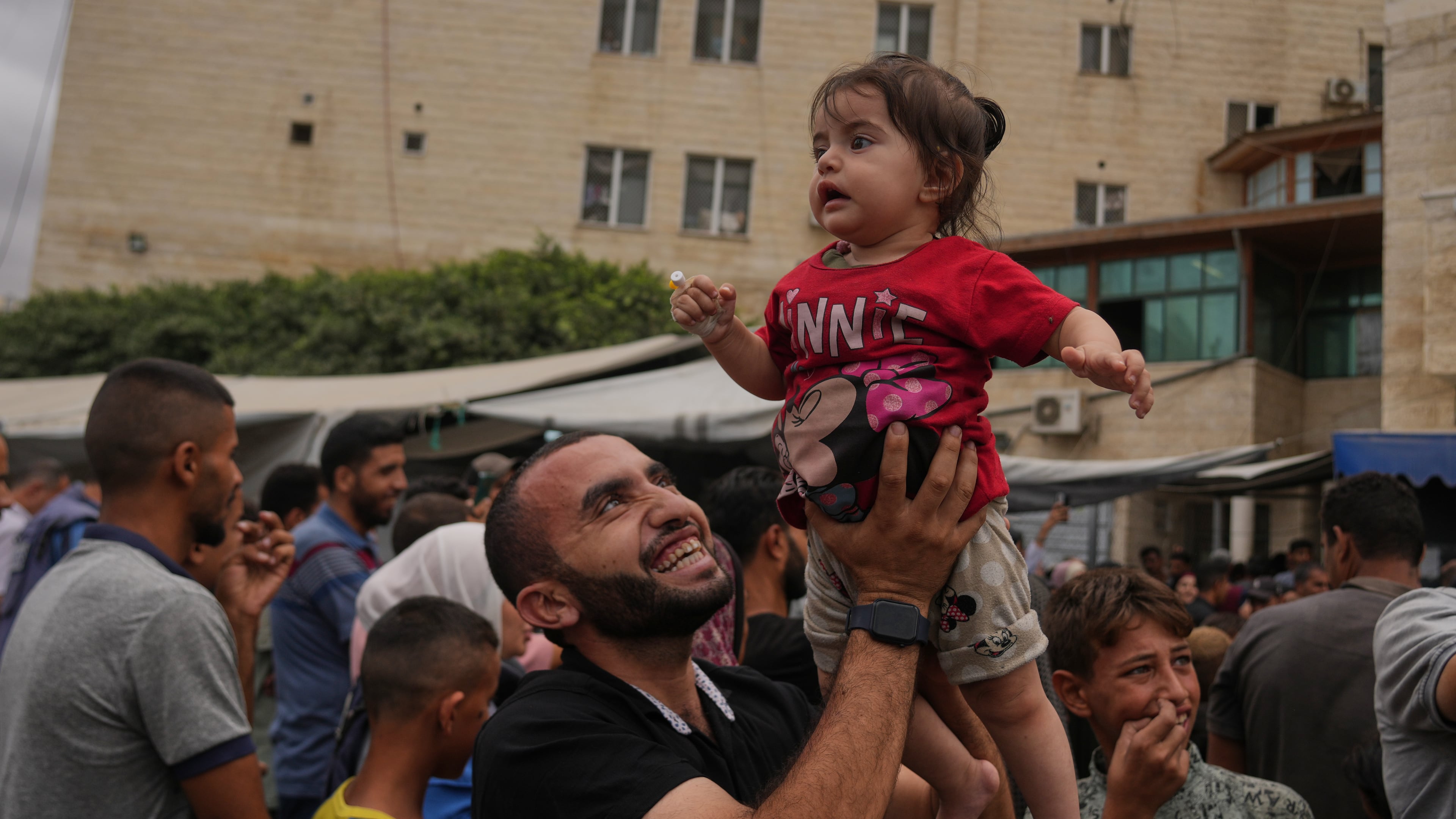 Palestinians celebrate following the announcement that Israel and Hamas have agreed to the first phase of a peace plan to pause the fighting, outside Al-Aqsa Hospital in Deir al-Balah, central Gaza Strip, Thursday, Oct. 9, 2025. (AP Photo/Abdel Kareem Hana)
