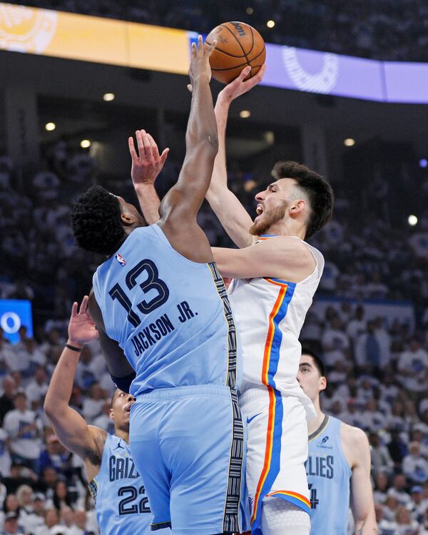 Oklahoma City Thunder forward Chet Holmgren (7) looks to shoot over Memphis Grizzlies forward Jaren Jackson Jr. (13) during the first half in Game 1 of an NBA first-round playoff series, Sunday, April 20, 2025, in Oklahoma City. (AP Photo/Nate Billings)