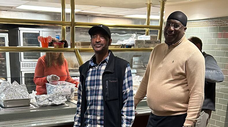 James Simmons (left) and Kelvin Boykin of Redemption After Prison (RAP) serve food at the Sunday morning prayer breakfast for the homeless and hungry at First Presbyterian Church of Atlanta. (Gayle White for The Atlanta Journal-Constitution)
