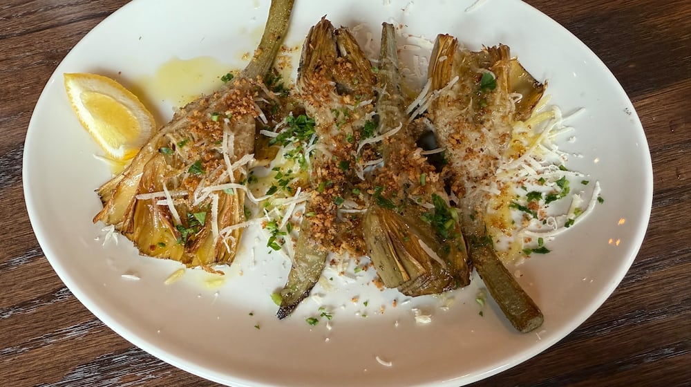 Coal-roasted artichokes at Krog Bar are perfectly charred on the outside and tender on the inside. (Angela Hansberger for the AJC)