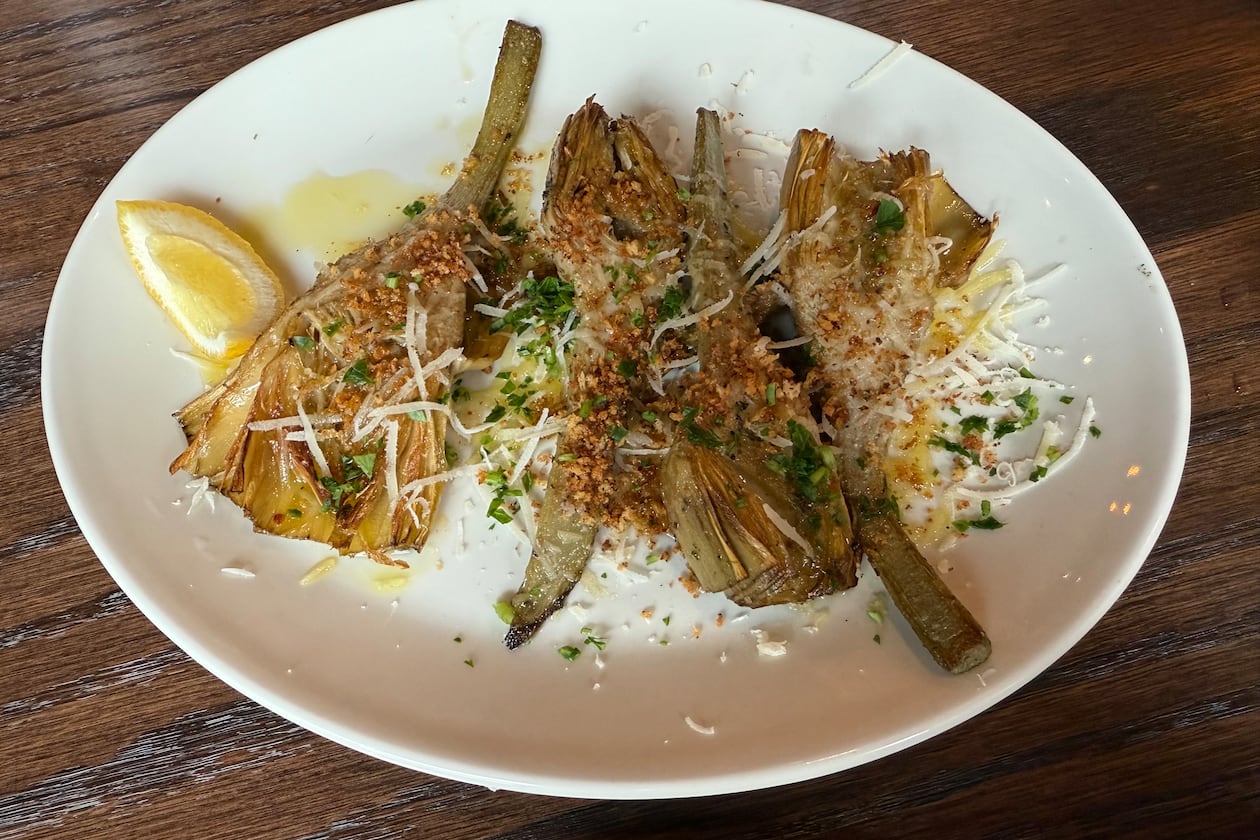 Coal-roasted artichokes at Krog Bar are perfectly charred on the outside and tender on the inside. (Angela Hansberger for the AJC)