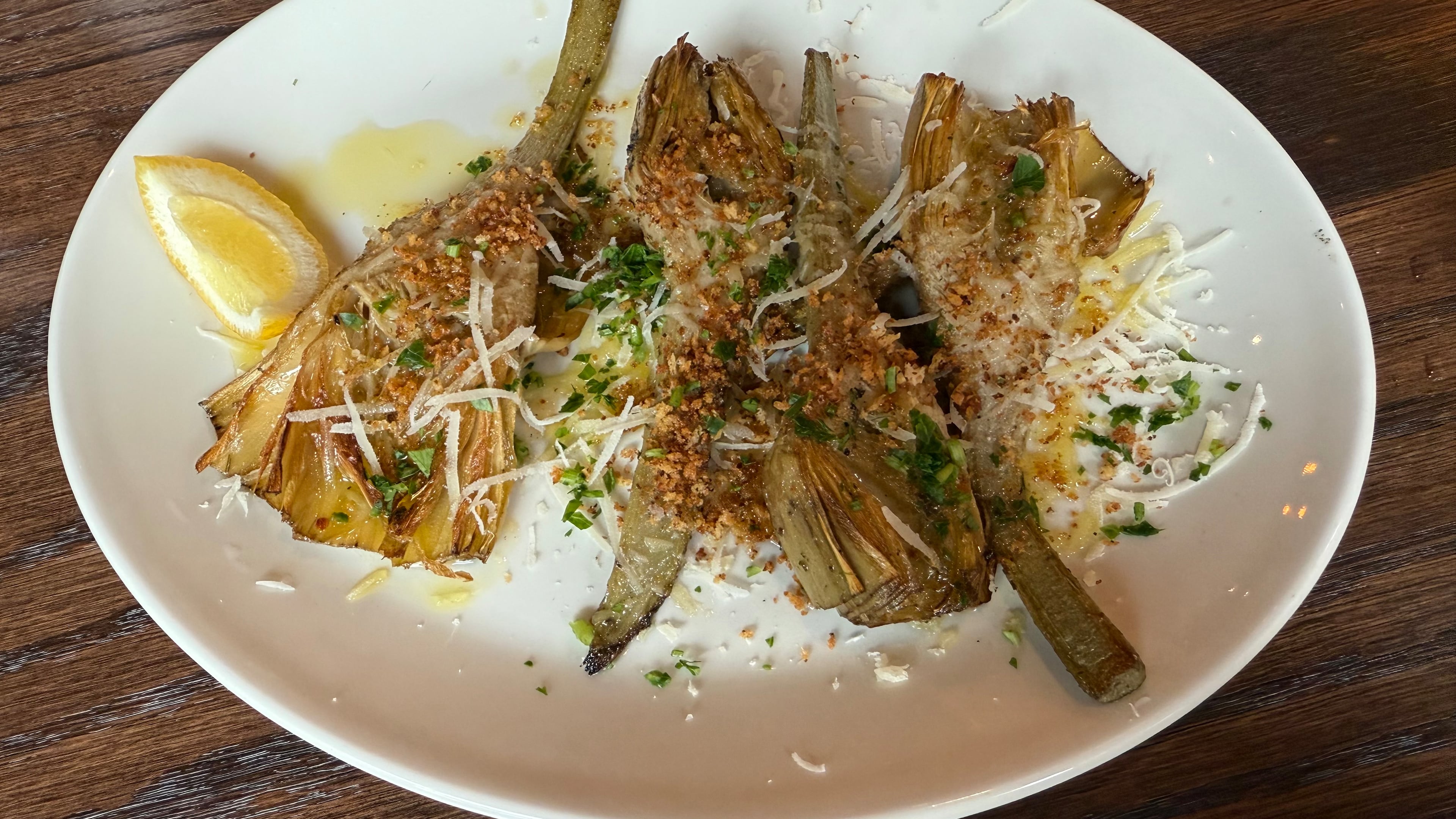 Coal-roasted artichokes at Krog Bar are perfectly charred on the outside and tender on the inside. (Angela Hansberger for the AJC)