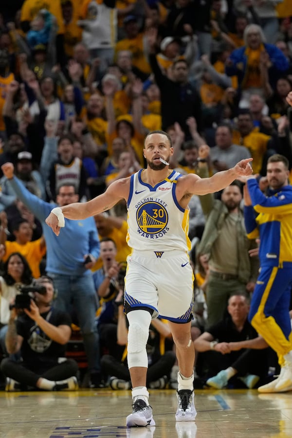 Golden State Warriors guard Stephen Curry (30) celebrates after making a 3-point basket during the second half of Game 3 of an NBA basketball first-round playoff series against the Houston Rockets in San Francisco, Saturday, April 26, 2025. (AP Photo/Jeff Chiu)