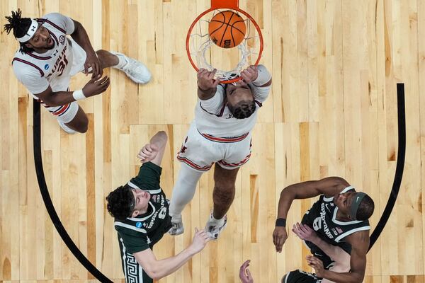 Auburn forward Johni Broome (4) dunks against against Michigan State during the second half in the Elite Eight of the NCAA college basketball tournament, Sunday, March 30, 2025, in Atlanta. (AP Photo/George Walker IV)