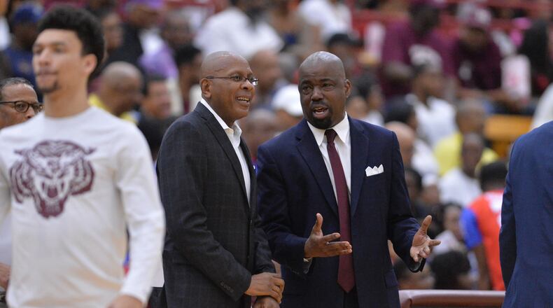 Clark Atlanta head coach Darrell Walker and Morehouse head coach Grady Brewer talk before their teams' matchup at Morehouse last month. Hyosub Shin/hshin@ajc.com