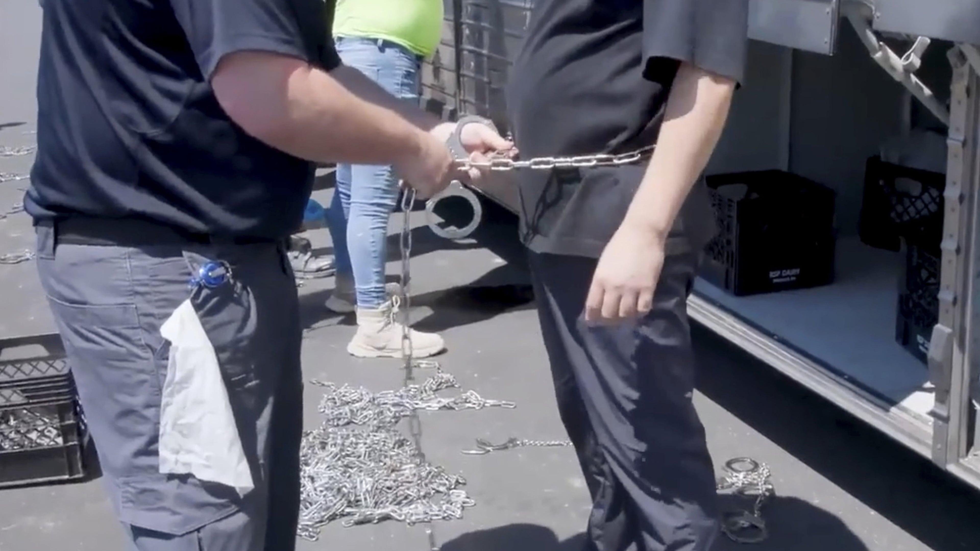 This image from video, provided by U.S. Immigration and Customs Enforcement via DVIDS, shows a person being handcuffed at the Hyundai Motor Group’s electric vehicle plant Sept. 4, 2025. (Corey Bullard/U.S. Immigration and Customs Enforcement via AP)