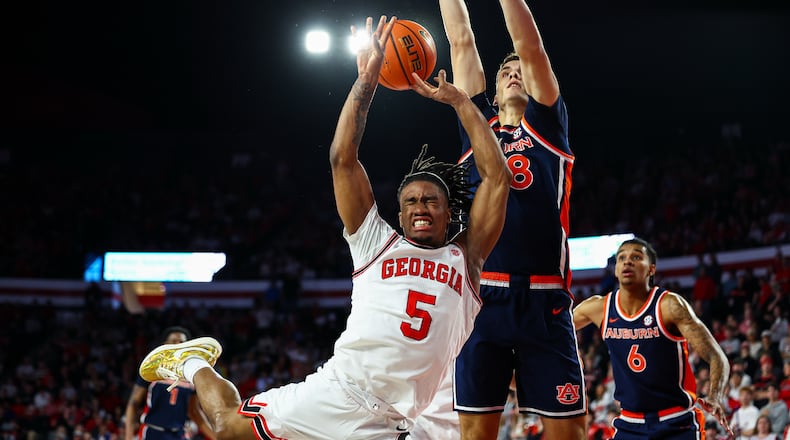 Georgia guard Jeremiah Wilkinson (5) shoots against Auburn forward Filip Jovic, right, during the first half of an NCAA college basketball game, Saturday, Jan. 3, 2026, in Athens, Ga. (AP Photo/Colin Hubbard)