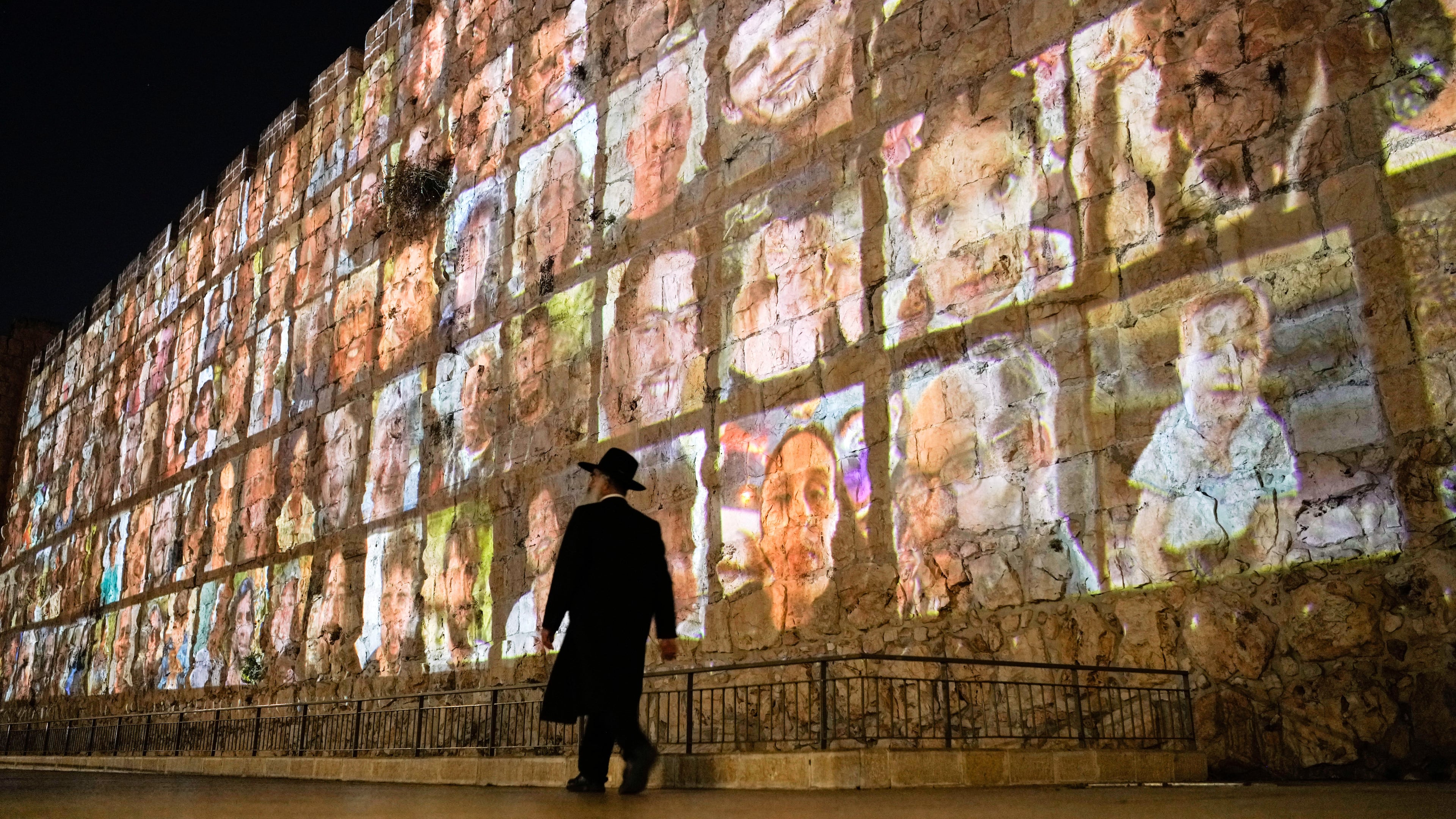 FILE - Photographs of Israeli hostages being held by Hamas militants are projected on the walls of Jerusalem's Old City, Nov. 6, 2023. The Islamic militant group killed around 1,200 people, mostly civilians, and abducted 251 others on Oct. 7, 2023. (AP Photo/Leo Correa, File)
