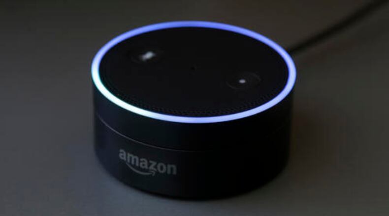 This Wednesday, March 2, 2016 photo shows an Echo Dot in San Francisco. Amazon.com is introducing two devices, the Amazon Tap and Echo Dot, that are designed to amplify the role that its voice-controlled assistant Alexa plays in people's homes and lives. (AP Photo/Jeff Chiu)