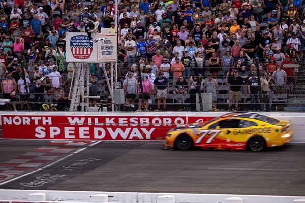 Carson Hocevar gets the checkered flag in the NASCAR All-Star Open auto race Sunday, May 18, 2025, in North Wilkesboro, N.C. (AP Photo/Scott Kinser)