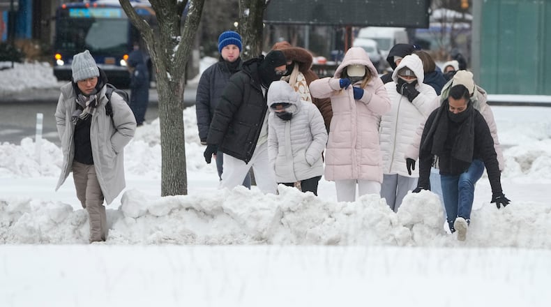 FILE - Pedestrians climb over snow banks to try and cross the streets in New York, Monday, Jan. 26, 2026. (AP Photo/Seth Wenig, File)