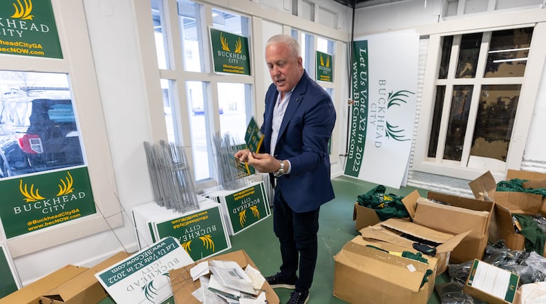 Bill White looks through some of the boxes that are left to move from the Buckhead City Committee Headquarters Thursday, Mar. 30, 2023.  (Steve Schaefer/steve.schaefer@ajc.com)