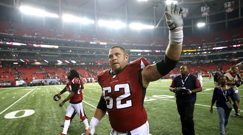 Former Falcons center Todd McClure waves to the home crowd during his final of 14 seasons with the team. JASON GETZ / JGETZ@AJC.COM