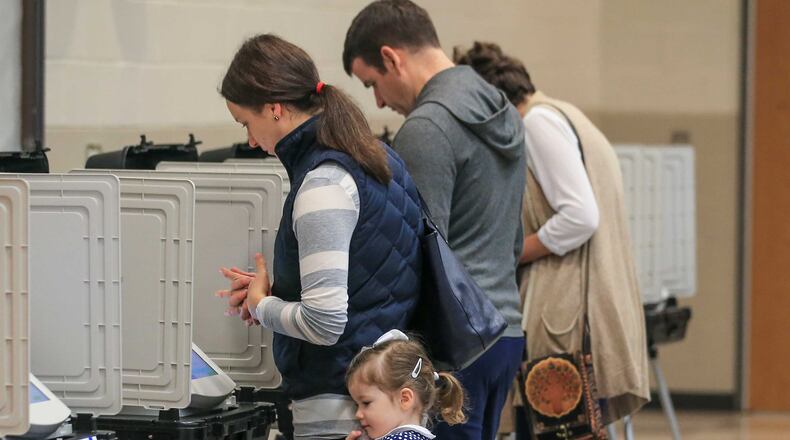 December 5, 2017 Atlanta: Rebecca Hammad, left, and her 4-year-old daughter, Caroline, voted at Henry W. Grady High School at 929 Charles Allen Dr NE in Atlanta on Tuesday. JOHN SPINK/JSPINK@AJC.COM