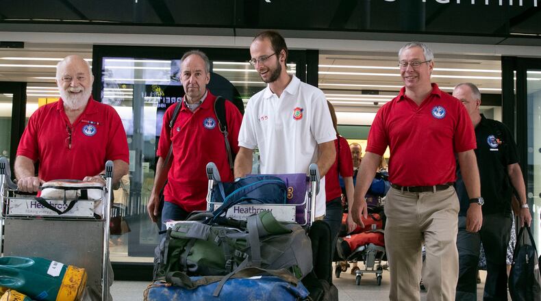 FILE PHOTO: Diver Josh Bratchley, centre, from the rescue mission, which helped to save 12 schoolboys and their soccer coach from a flooded cave in Thailand, arrives back at London's Heathrow Airport.