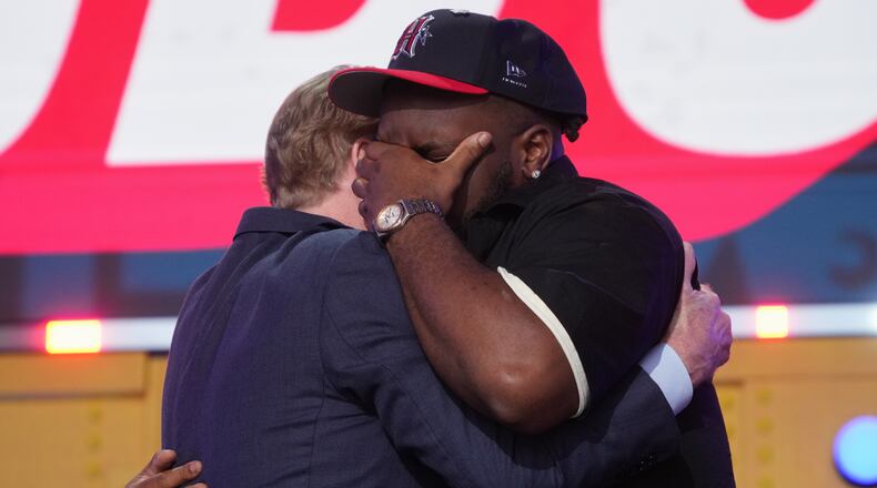 Ohio State defensive lineman Kayden McDonald, right, reacts with NFL Commissioner Roger Goodell after being chosen by the Houston Texans with the 36th overall pick during the second round of the NFL football draft, Friday, April 24, 2026, in Pittsburgh. (AP Photo/Gene J. Puskar)