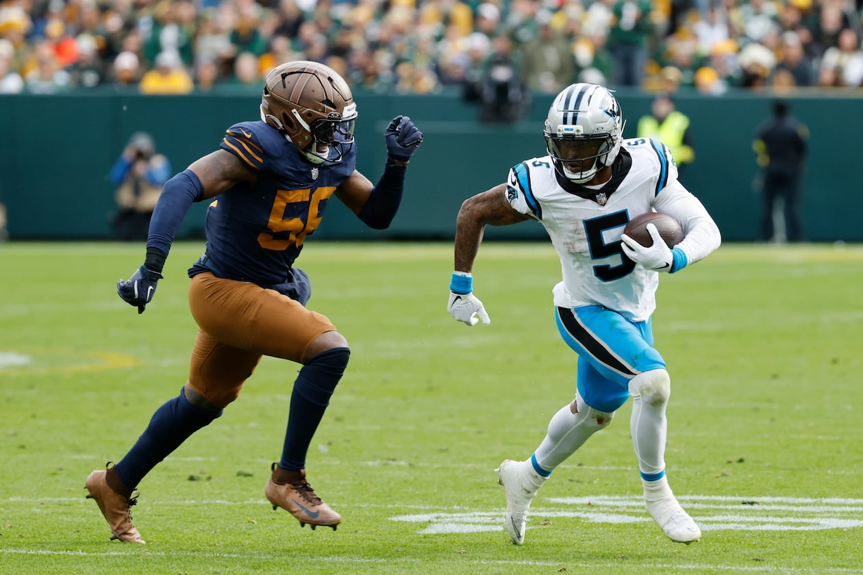 Panthers running back Rico Dowdle (right) runs against Packers defensive end Kingsley Enagbare on Sunday, Nov. 2, 2025, in Green Bay, Wis. Dowdle is turning in a spectacular season for Carolina. (Mike Roemer/AP)