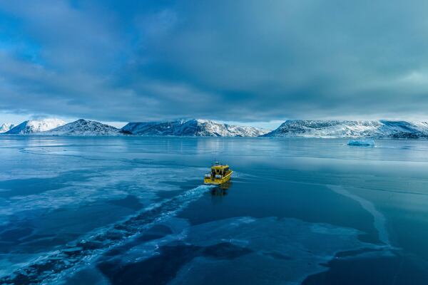 A boat rides though a frozen sea inlet outside of Nuuk, Greenland, March 6, 2025. (AP Photo/Evgeniy Maloletka)