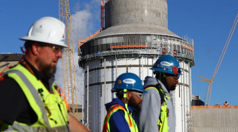 Some of the thousands of construction workers pass by the exterior of unit 4 at Georgia Power's Plant Vogtle nuclear project on Tuesday, Dec 14, 2021, in Waynesboro, Georgia. “Curtis Compton / Curtis.Compton@ajc.com”`