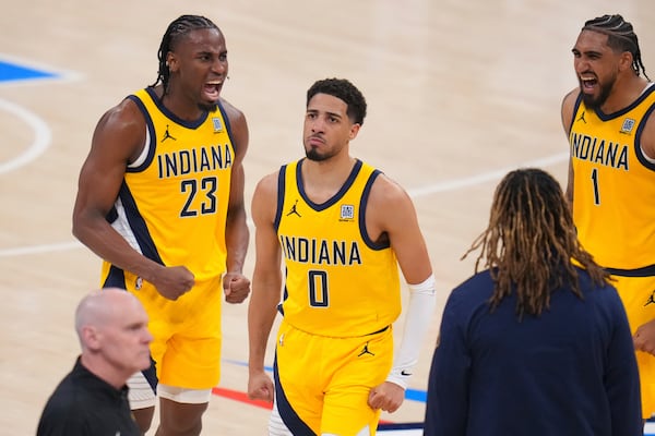 Indiana Pacers guard Tyrese Haliburton (0) celebrates with forward Aaron Nesmith (23) and forward Obi Toppin (1) after making a 3-pointer against the Oklahoma City Thunder during the second half of Game 1 of the NBA Finals basketball series Thursday, June 5, 2025, in Oklahoma City. (AP Photo/Julio Cortez)