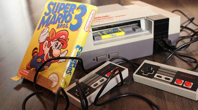 An unopened copy of Nintendo’s Super Mario Bros. (not pictured) that was bought in 1986 and then forgotten about in a desk drawer has sold at auction for $660,000. (AJC file photo)