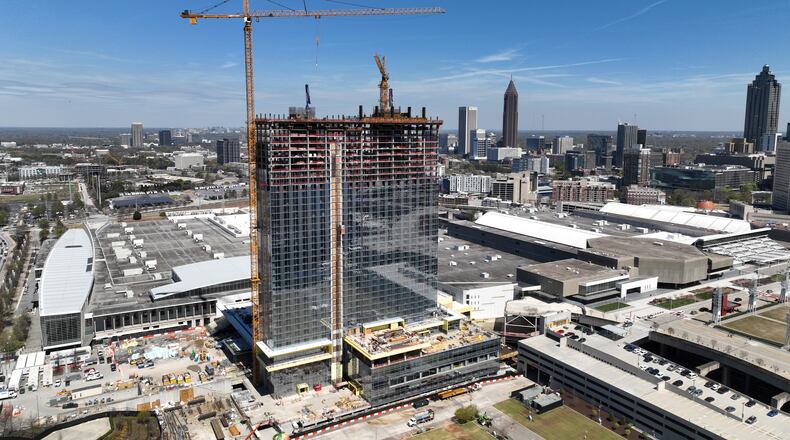 Aerial photograph shows construction site of Signia by Hilton Atlanta at Georgia World Congress Center, as construction crew prepare for topping out ceremony, Thursday, March 23, 2023, in Atlanta. Plans are in motion for GWCCA’s new headquarter hotel Signia by Hilton Atlanta. Featuring close to 1,000 rooms, this premier full-service hotel will sit on the northwest corner of the campus, adjacent to Building C of Georgia World Congress Center. (Hyosub Shin / Hyosub.Shin@ajc.com)