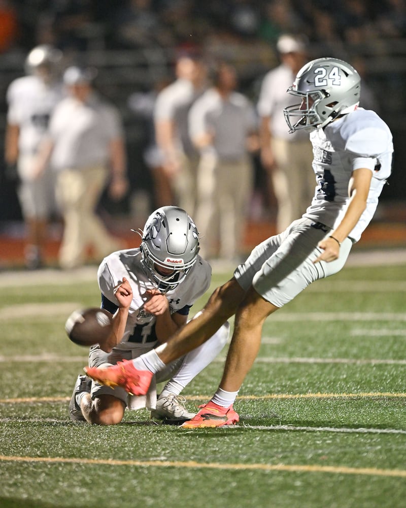 East Jackson quarterback Jayden Gibson (left) holds the ball for a field goal attempt by Cade Cashwell during the second half of play Friday, Sept. 26, 2025, at Hebron Christian Academy. (Daniel Varnado for the AJC)