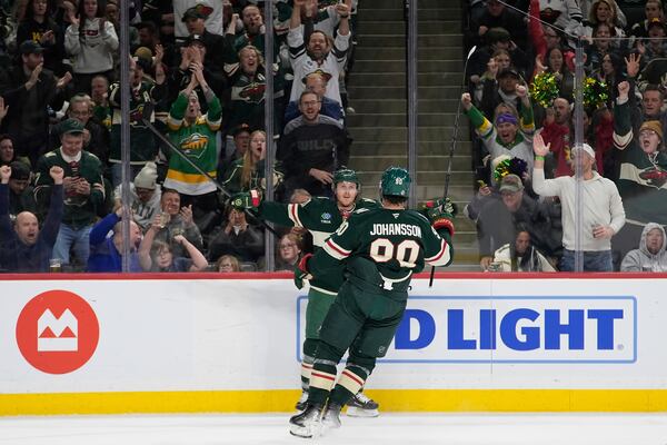 Minnesota Wild left wing Marcus Johansson (90) celebrates toward center Gustav Nyquist (41) after scoring a goal during the first period of an NHL hockey game against the San Jose Sharks, Wednesday, April 9, 2025, in St. Paul, Minn. (AP Photo/Abbie Parr)