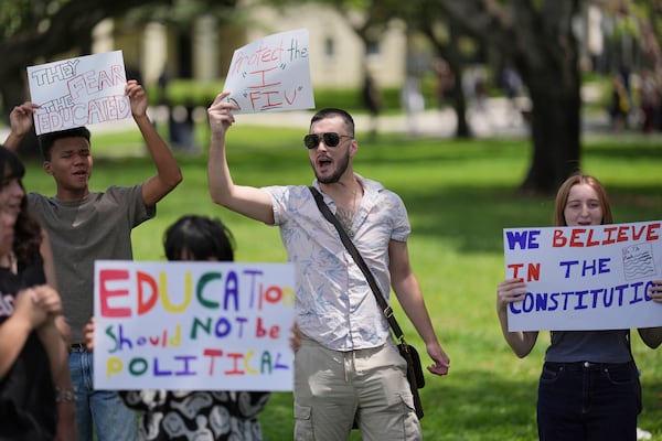 FILE - A group of Florida International University students protest against cuts in federal funding and an agreement by campus police to partner with Immigration and Customs Enforcement, on the FIU campus on a day of protests around the country in support of higher education, April 17, 2025, in Miami. (AP Photo/Rebecca Blackwell, File)
