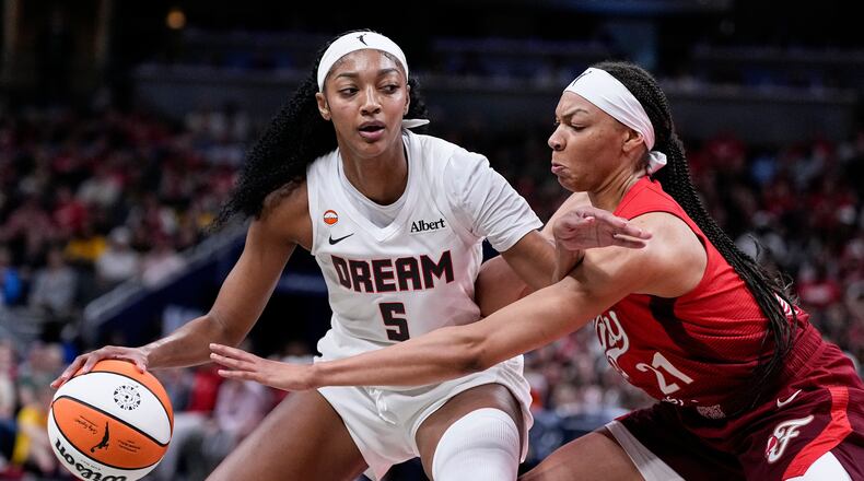 Atlanta Dream forward Angel Reese (5) works around Indiana Fever forward Makayla Timpson (21) in the second half of a WNBA basketball game in Indianapolis, Thursday, June 18, 2026. Reese led the Dream with 21 points and added 11 rebounds on Thursday night. (Michael Conroy/AP)