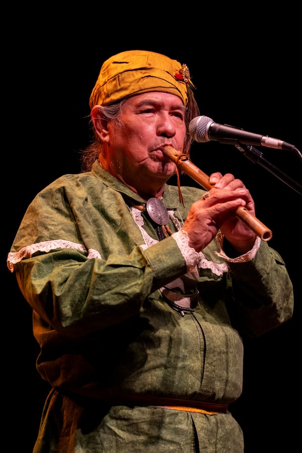Muscogee (Creek) elder William Harjo plays a flute he made by hand and tells stories for the audience at Art of Activism at 7 Stages Theatre in Atlanta on Friday, Nov. 14, 2025. (Olivia Bowdoin for the AJC)